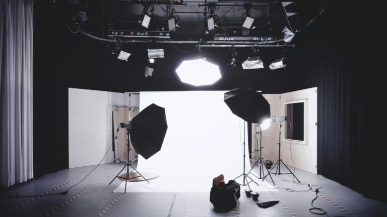 Empty studio set up for photography shoot with cameras and white background