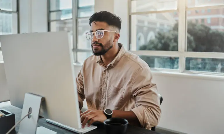 young male attorney shown working on computer, updating his law firm's website