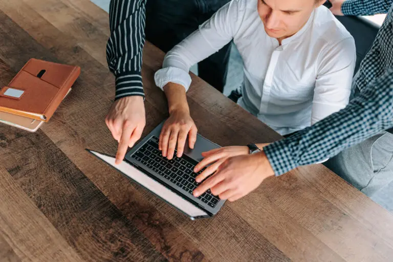 Top view of teams' hands as they review website design for law firm