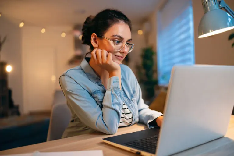 young woman looking at her laptop screen