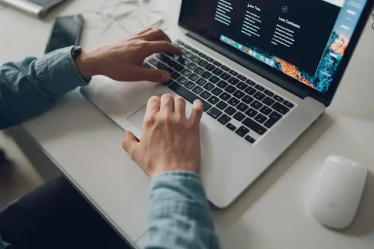 hands of young man typing on laptop keyboard