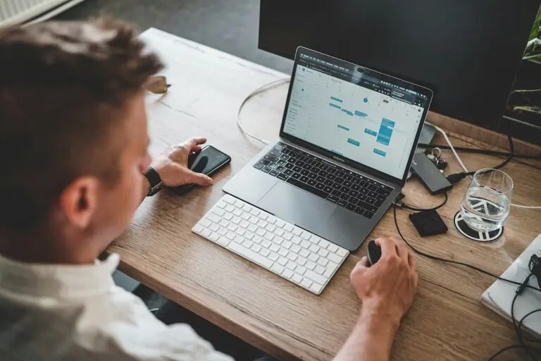 Photo of professional male looking at weekly calendar on laptop